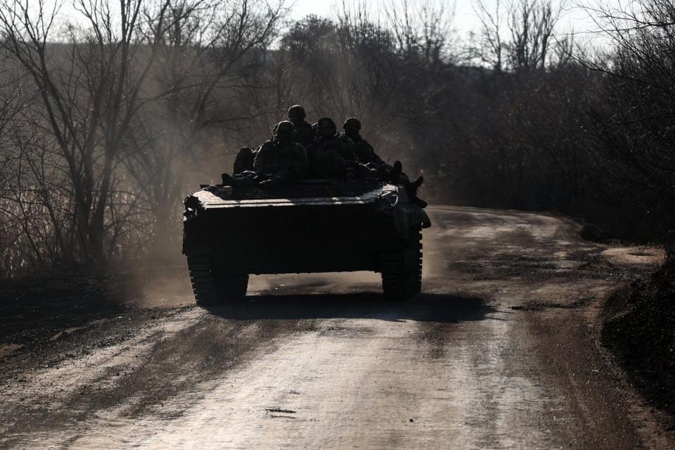 Ukrainian soldiers ride an infantry fighting vehicle along a road not far from Bakhmut, Donetsk region, on Sunday amid the Russian invasion of Ukraine (AFP via Getty Images)