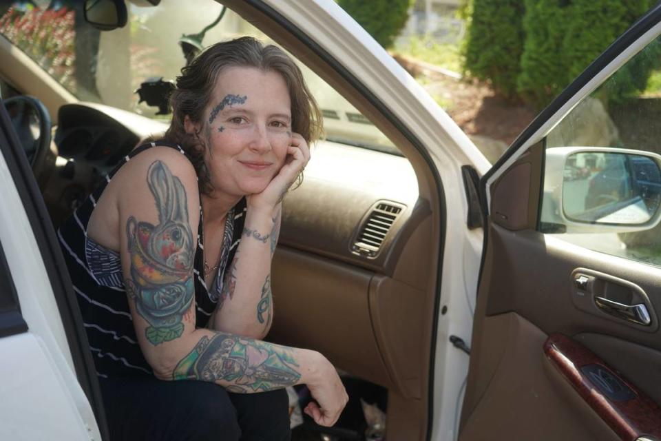 Cassandra sits in the front passenger seat of her vehicle on July 27, 2023, in a parking lot in downtown Bellingham, Wash. She is currently living in the vehicle with her husband and six children.