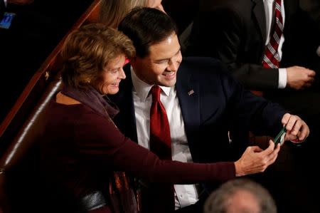 Republican U.S. presidential candidate Senator Marco Rubio (R) takes a selfie with U.S. Senator Lisa Murkowski (L) as they wait for U.S. President Barack Obama's State of the Union address to a joint session of Congress in Washington, January 12, 2016. REUTERS/Jonathan Ernst