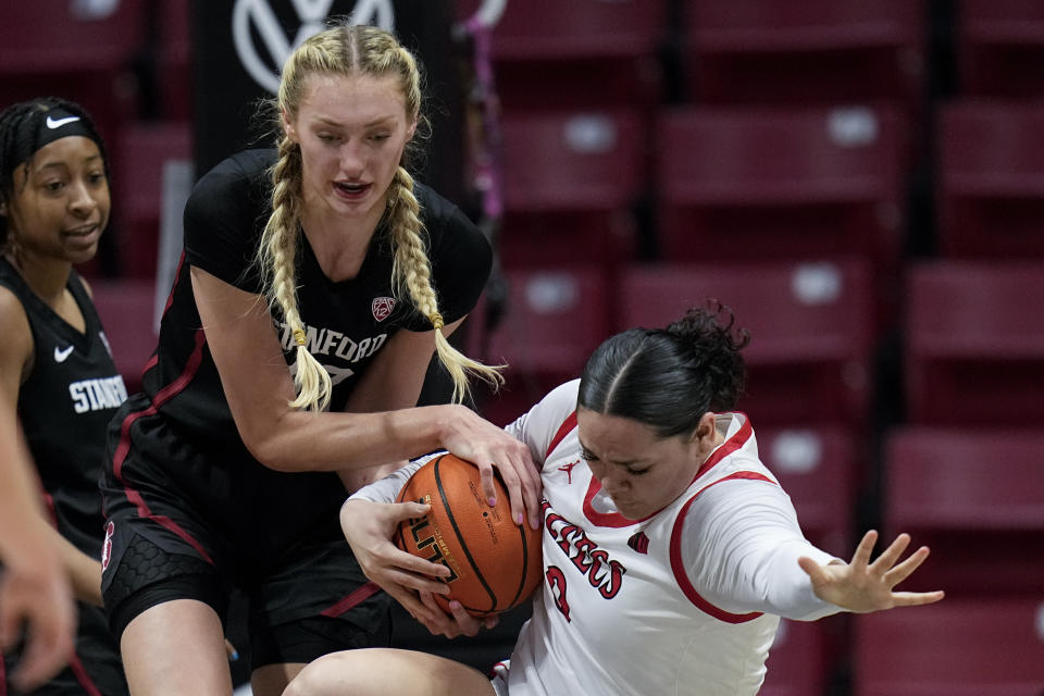 Stanford forward Cameron Brink, left, battles San Diego State guard Alyssa Jackson for the ball during the first half of an NCAA college basketball game, Friday, Dec. 1, 2023, in San Diego. (AP Photo/Gregory Bull)