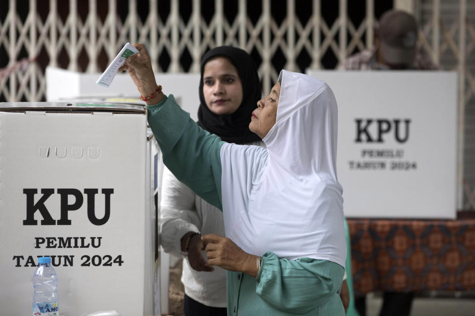 FILE - A woman casts her ballot at a polling station during the election in Medan, Indonesia, Wednesday, Feb. 14, 2024. Prabowo Subianto’s rise as Indonesia’s apparent next president is a dramatic comeback from a notorious past, which saw the United States banning his entry over human rights and the Indonesian army, where he led the special forces, expelling him.(AP Photo/Binsar Bakkara, File)