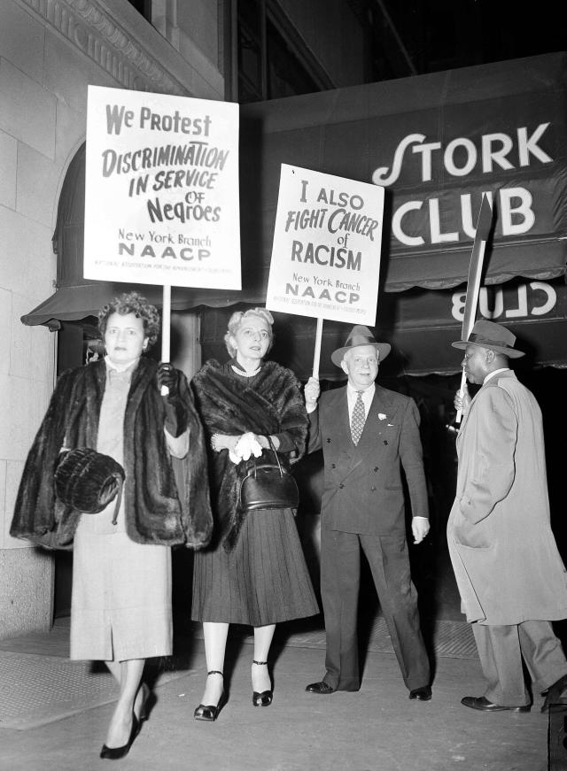 FILE- A protest picket line organized by the New York branch of the National Association for the Advancement of Colored People, parades in front of the Stork Club in New York, Oct. 22, 1951. From left, Bessie Buchanan, personal secretary to actress Josephine Baker; Laura Hobson, author of "Gentleman's Agreement," and Walter White, executive secretary of the NAACP. The NAACP alleges Miss Baker and party were refused food service at the club on Oct. 16. France is inducting Missouri-born cabaret dancer Josephine Baker, who was also a French World War II spy and civil rights activist – into its Pantheon. She is the first Black woman honored in the final resting place of France’s most revered luminaries. On the surface, it’s a powerful message against racism, bt by choosing a U.S.-born figure -- entertainer Josephine Baker – critics say France is continuing a long tradition of decrying racism abroad while obscuring it at home. (AP Photo/Marty Lederhandler, File)