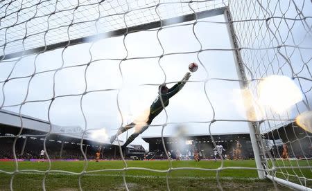 Britain Football Soccer - Fulham v Hull City - FA Cup Fourth Round - Craven Cottage - 29/1/17 Fulham's Marcus Bettinelli makes a save Reuters / Dylan Martinez Livepic EDITORIAL USE ONLY. No use with unauthorized audio, video, data, fixture lists, club/league logos or "live" services. Online in-match use limited to 45 images, no video emulation. No use in betting, games or single club/league/player publications. Please contact your account representative for further details.