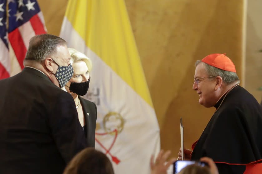 U.S. Secretary of State Mike Pompeo, left, and U.S. Ambassador to the Holy See Callista Gingrich greet Cardinal Raymond Burke, right, as they attend the "Advancing and Defending International Religious Freedom Through Diplomacy" symposium, in Rome, Wednesday, Sept. 30, 2020. (AP Photo/Andrew Medichini)