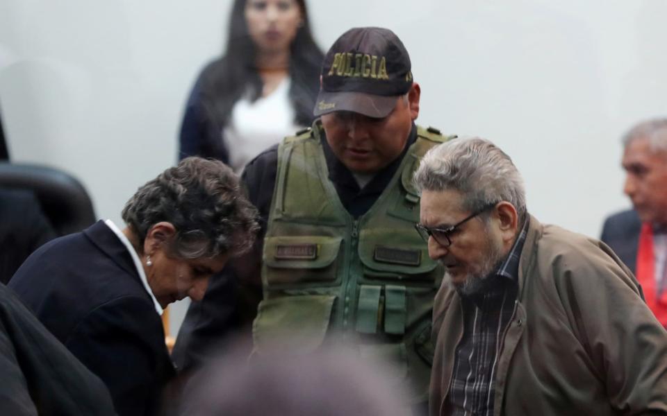 Shining Path founder Abimael Guzman and his wife and second leader Elena Iparraguirre attend a trial during sentence of a 1992 Shining Path car bomb case