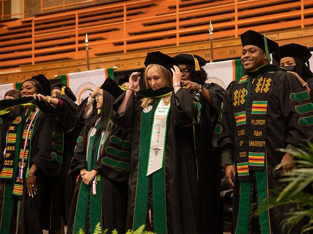 FAMU College of Pharmacy and Pharmaceutical Sciences graduates participate in a hooding ceremony.