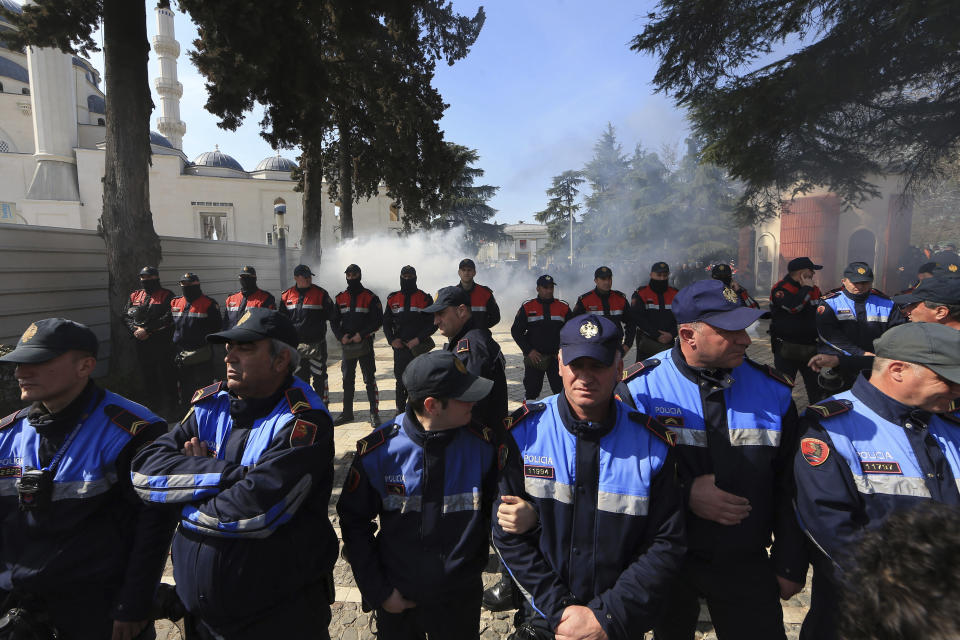 Police officers stand guard during an anti-government rally in Tirana, Albania, Thursday, March 21, 2019. Thousand opposition protesters have gathered in front of Albania's parliament building calling for the government's resignation and an early election. Rally is part of the center-right Democratic Party-led opposition's protests over the last month accusing the leftist Socialist Party government of Prime Minister Edi Rama of being corrupt and linked to organized crime. (AP Photo/ Hektor Pustina)