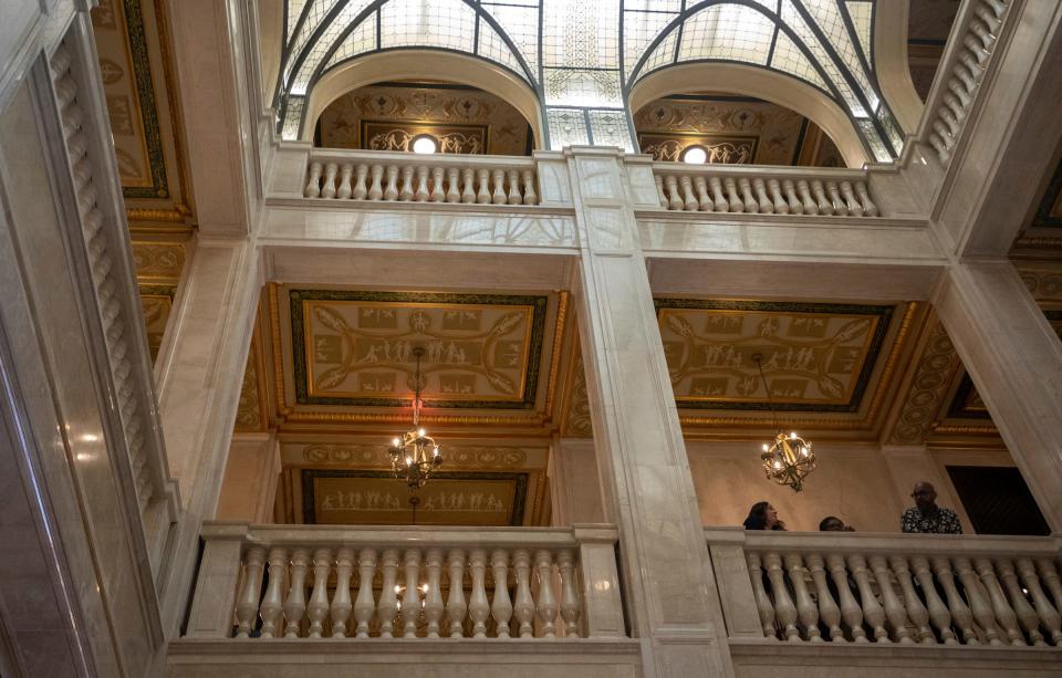 People stand inside the Book Tower building during its ribbon-cutting ceremony on Thursday, June 8, 2023.