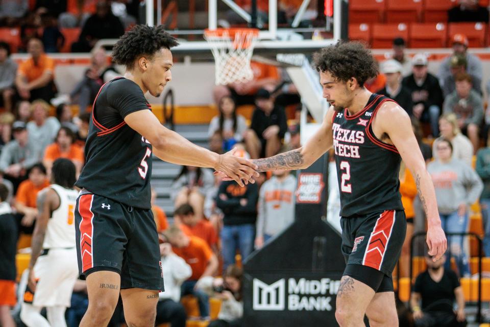Texas Tech guard Darrion Williams (5) and Texas Tech guard Pop Isaacs (2) slap hands during a break in play at Big 12 basketball game against Oklahoma State, Tuesday, March 5, 2024 at Gallagher-Iba Arena in Stillwater, Okla.