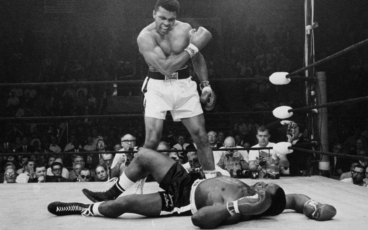 Heavyweight champion Muhammad Ali stands over fallen challenger Sonny Liston, shouting and gesturing shortly after dropping Liston with a short hard right to the jaw in Lewiston, Maine. Ali, the magnificent heavyweight champion whose fast fists and irrepressible personality transcended sports and captivated the world, has died according to a statement released by his family Friday, June 3, 2016. He was 74