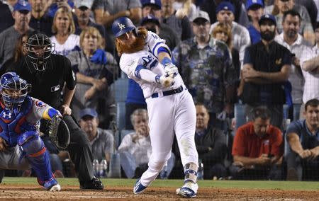 Oct 15, 2017; Los Angeles, CA, USA; Los Angeles Dodgers third baseman Justin Turner (10) hits a walk off home run in the ninth inning to defeat the Chicago Cubs in game two of the 2017 NLCS playoff baseball series at Dodger Stadium. Mandatory Credit: Robert Hanashiro-USA TODAY Sports