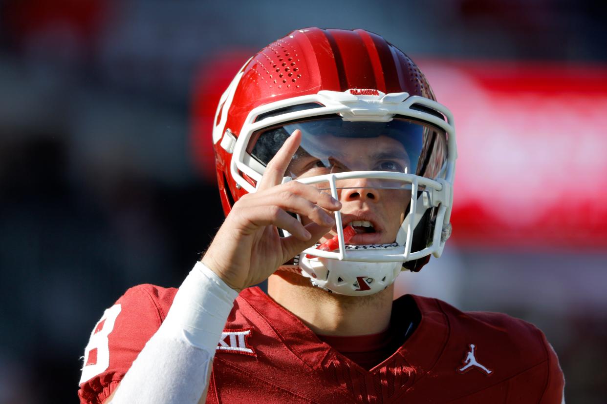 Oklahoma Sooners quarterback Dillon Gabriel (8) gestures as he warms up before a college football game between the University of Oklahoma Sooners (OU) and the TCU Horned Frogs at Gaylord Family-Oklahoma Memorial Stadium in Norman, Okla., Friday, Nov. 24, 2023.