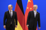 German Finance Minister Olaf Scholz, left, and Chinese Vice Premier Liu He arrive for the China-Germany High Level Financial Dialogue at the Diaoyutai State Guesthouse in Beijing, Friday, Jan. 18, 2019. (AP Photo/Andy Wong, Pool)