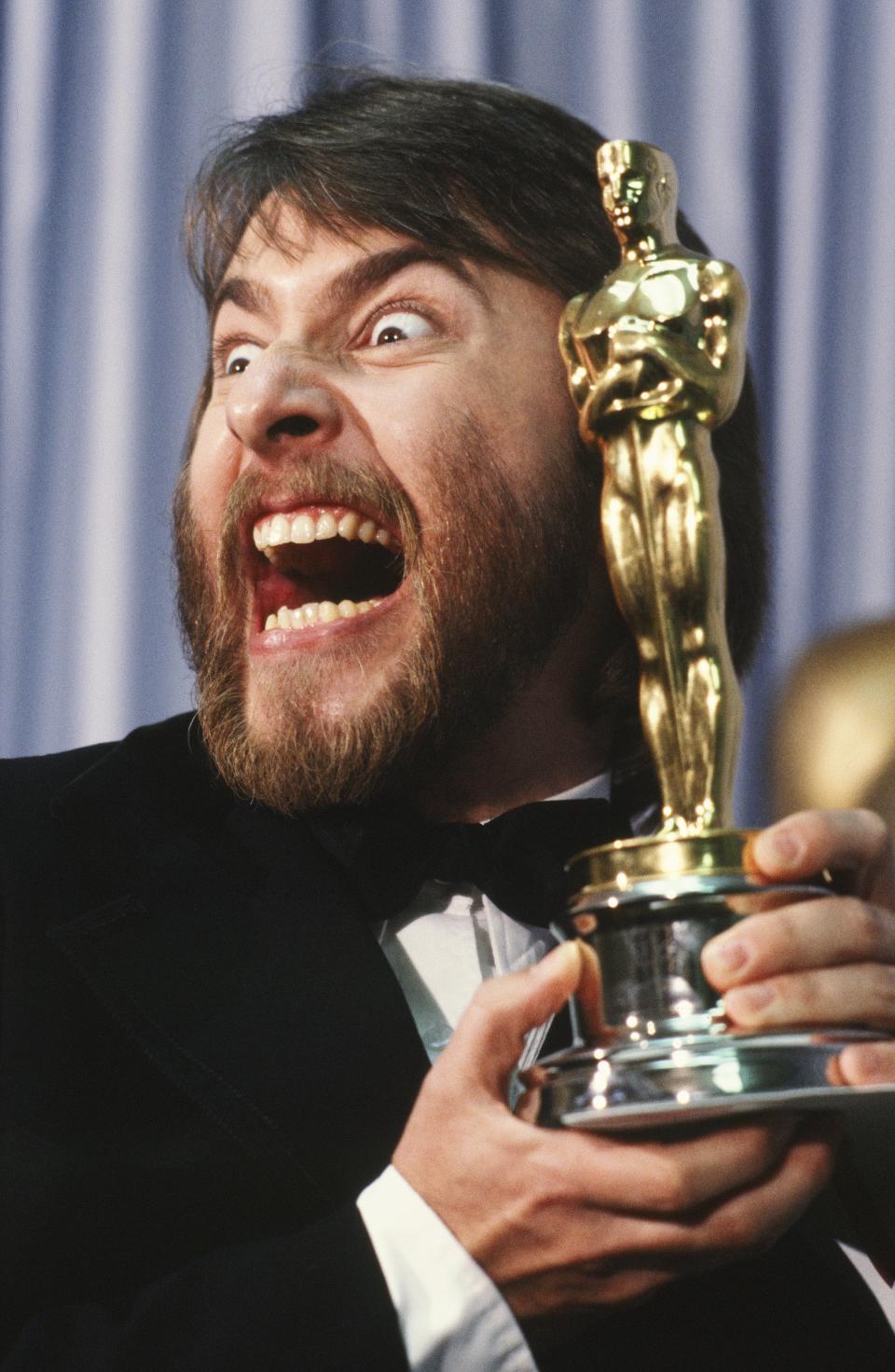 LOS ANGELES, CA - 1981:  Academy Award-winning makeup artist, Rick Baker, poses in a 1981 Los Angeles, California, backstage photo shoot with his Oscar. Baker won the award for his work on the film 