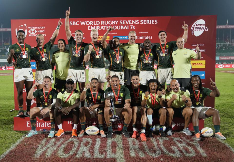 South Africa players celebrate with their trophy after they beat Ireland during the final match of the Emirates Airline Rugby Sevens, in Dubai, United Arab Emirates, Saturday, Dec. 3, 2022. (AP Photo/Kamran Jebreili)