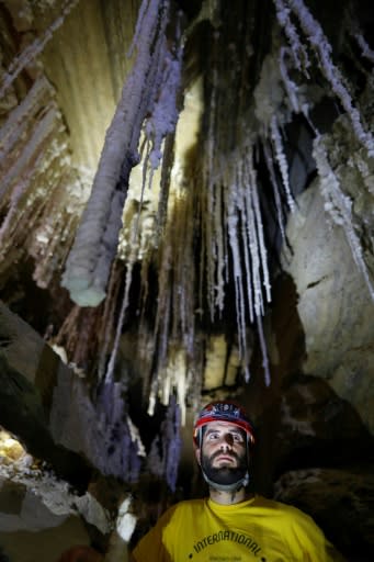 Israeli cave explorer Boaz Langford stands in front of salt stalactites in the Malham cave inside Mount Sodom, located at the southern part of the Dead Sea in Israel