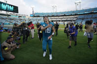 Jacksonville Jaguars quarterback Trevor Lawrence tosses his wristband to a fan after a win over the Las Vegas Raiders in an NFL football game Sunday, Nov. 6, 2022, in Jacksonville, Fla. The Jaguars won 27-20. (AP Photo/John Raoux)