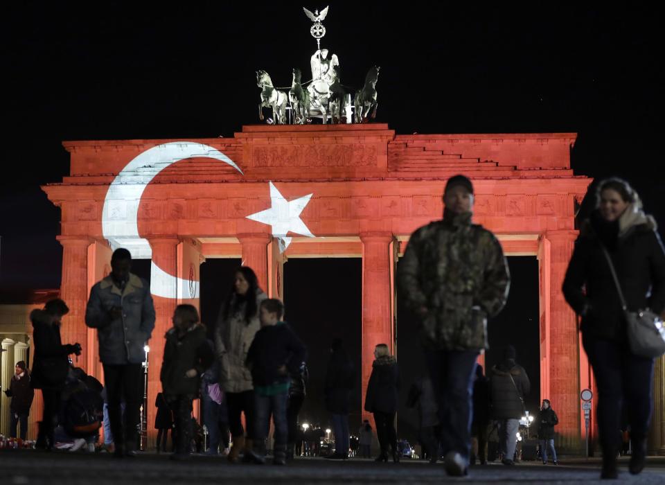 The Brandenburg Gate in Berlin, Germany, is illuminated in the colours of the flag of Turkey on Monday, Jan. 2, 2017 the day after an assailant killed dozens of people in a crowded Istanbul nightclub during New Year's celebrations on Sunday. (AP Photo/Michael Sohn)