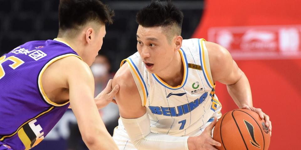 Jeremy Lin holds the ball and looks at a defender during a game in China in 2022.