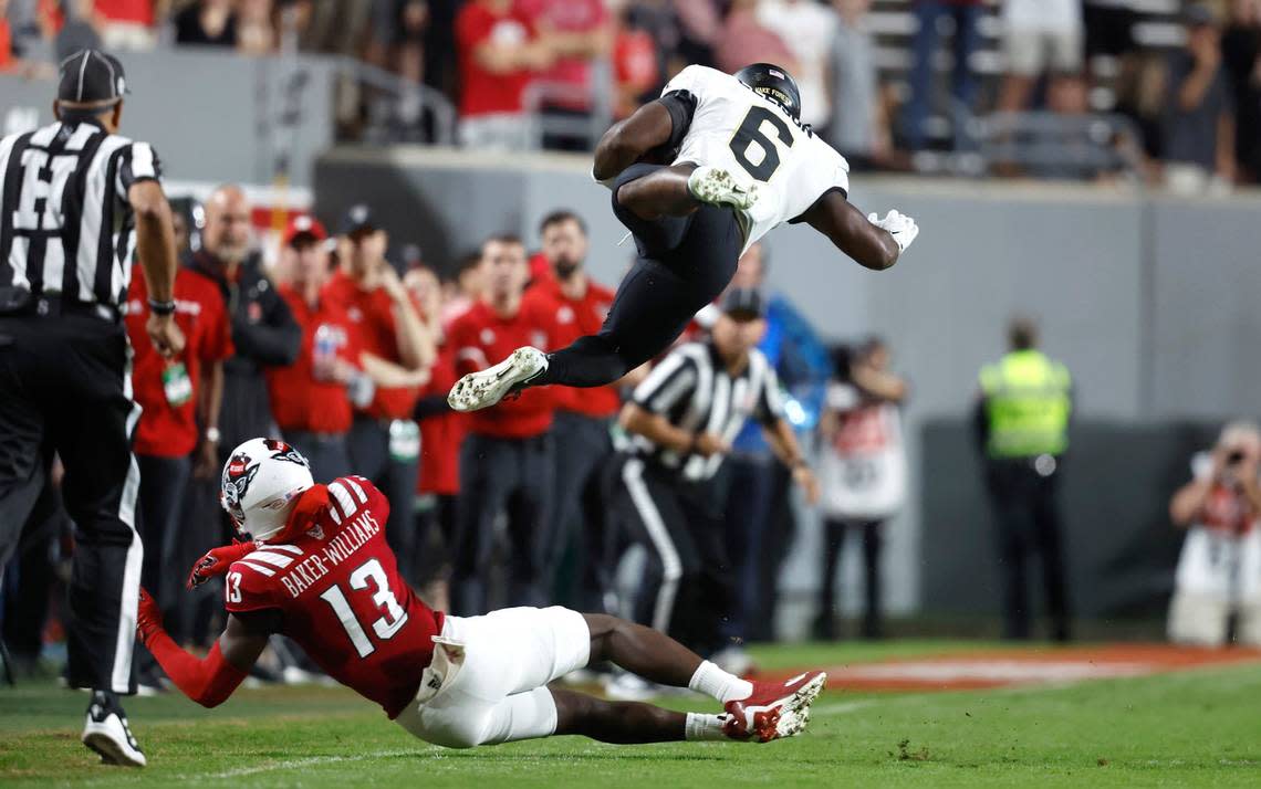 N.C. State’s Tyler Baker-Williams (13) tackles Wake Forest’s Justice Ellison (6) during the first half of N.C. State’s game against Wake Forest at Carter-Finley Stadium in Raleigh, N.C., Saturday, Nov. 5, 2022.