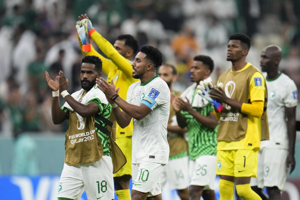 Players of Saudi Arabia clap after the World Cup group C soccer match between Saudi Arabia and Mexico, at the Lusail Stadium in Lusail, Qatar, Thursday, Dec. 1, 2022. (AP Photo/Manu Fernandez)