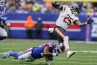 New York Giants cornerback Adoree' Jackson (22) trips up Chicago Bears running back Trestan Ebner (25) during the third quarter of an NFL football game, Sunday, Oct. 2, 2022, in East Rutherford, N.J. (AP Photo/John Minchillo)