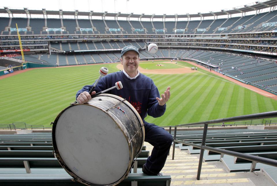 Cleveland baseball fan John Adams poses in his usual centerfield bleacher seat with his ever-present bass drum before a game against the Kansas City Royals on April 27, 2011, in Cleveland.