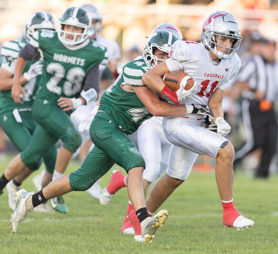 Sandy Valley's Troy Snyder runs for a gain in the first half as Malvern's Dante Passio works to bring him down, Friday, Sept. 15, 2023.