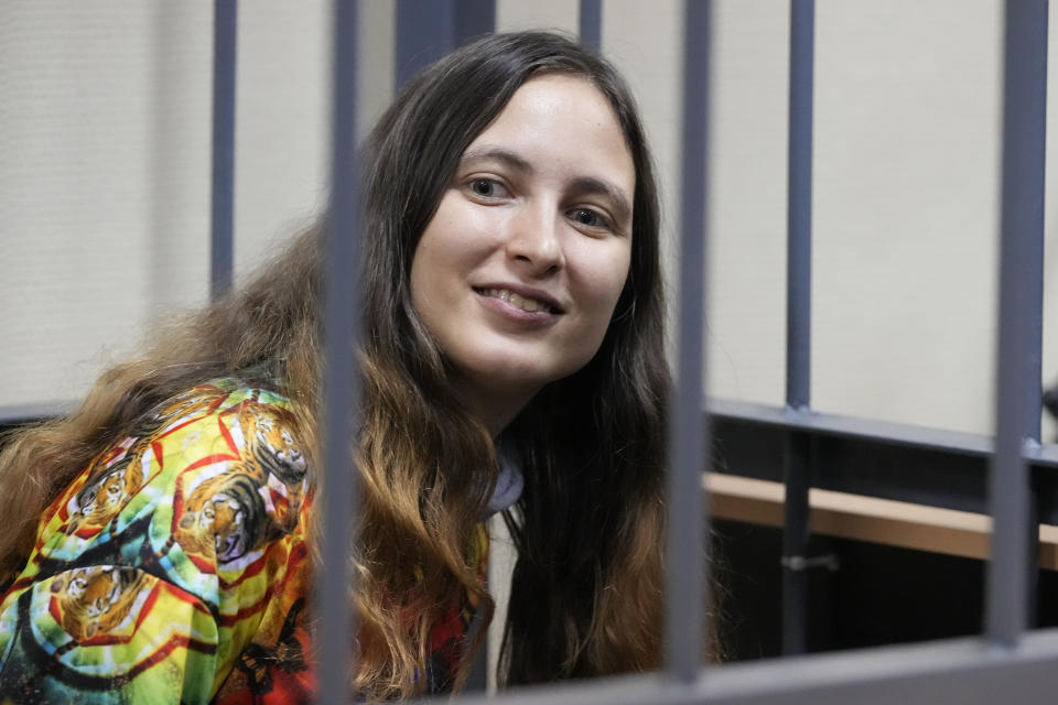Sasha Skochilenko, a 33-year-old artist and musician, sits in a defendant's cage in a courtroom during a hearing in the Vasileostrovsky district court in St. Petersburg, Russia, on Thursday, Oct. 19, 2023. Skochilenko was arrested in April 2022 and faces charges of spreading false information about the army after replacing supermarket price tags with slogans protesting against Russia's military operation in Ukraine. (AP Photo/Dmitri Lovetsky)