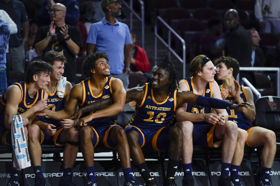 Players on the UC Irvine bench react in the final seconds of the team's win over Southern California in an NCAA college basketball game Tuesday, Nov. 14, 2023, in Los Angeles. (AP Photo/Ryan Sun)