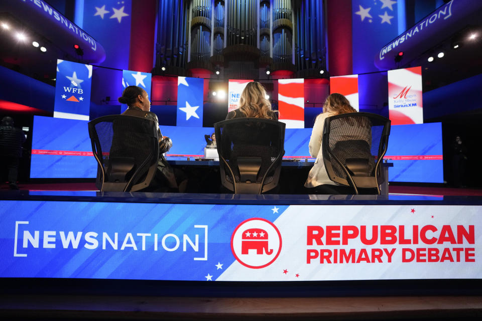 Stand-ins assume positions of candidates and moderators to check sound and lighting, in advance of a Republican presidential primary debate hosted by NewsNation on Wednesday, Dec. 6, 2023, at the Moody Music Hall at the University of Alabama in Tuscaloosa, Ala. (AP Photo/Gerald Herbert)