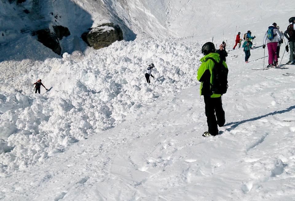 Rescue crews work on the avalanche site in the ski resort of Crans-Montana, Switzerland (EPA)