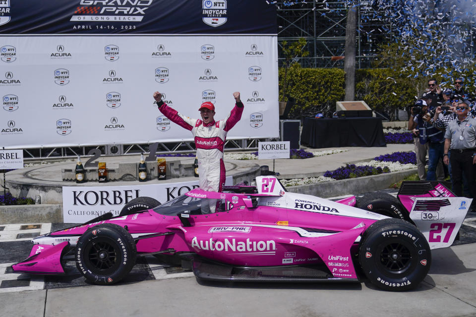 Kyle Kirkwood celebrates during the victory ceremony after winning the IndyCar Grand Prix of Long Beach auto race, Sunday, April 16, 2023, in Long Beach, Calif. (AP Photo/Jae C. Hong)