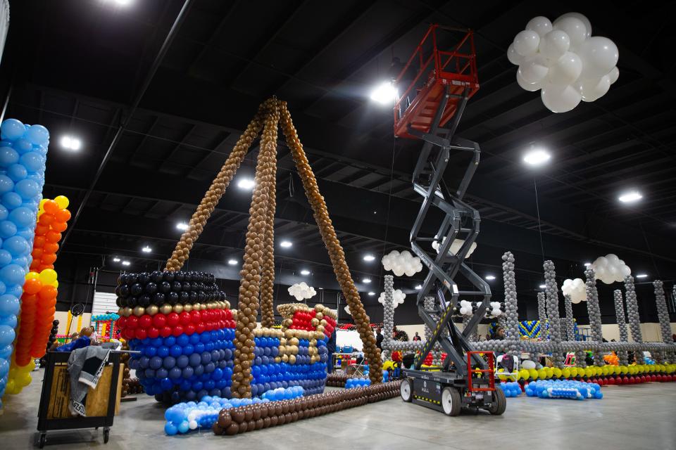 A giant pirate ships stands next to a sky jack on Wednesday, April 24, 2024, ahead of the Big Balloon Build charity event this weekend at the Northern Indiana Event Center in Elkhart County.