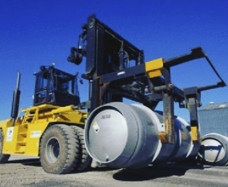 FILE - In this. file photo, released on Wednesday, Nov. 6, 2019 by the Atomic Energy Organization of Iran, a forklift carries a cylinder containing uranium hexafluoride gas for the purpose of injecting the gas into centrifuges in Iran's Fordo nuclear facility. An Iranian government spokesman said Tehran has begun enriching uranium up to 20% at an underground facility. The state-run IRNA news agency on Monday, Dec. 4, 2021, quoted Ali Rabiei saying President Hassan Rouhani had given the order for the move at the Fordo facility. (Atomic Energy Organization of Iran via AP, File)