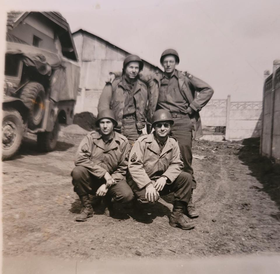 John T. Cantrell is shown kneeling on the right with fellow Ghost Army soldiers.