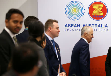 Australian Prime Minister Malcolm Turnbull walks past delegates as he arrives for an Emerging Leaders roundtable during the one-off summit of 10-member Association of Southeast Asian Nations (ASEAN) in Sydney, Australia, March 16, 2018. Rick Rycroft/Pool via REUTERS