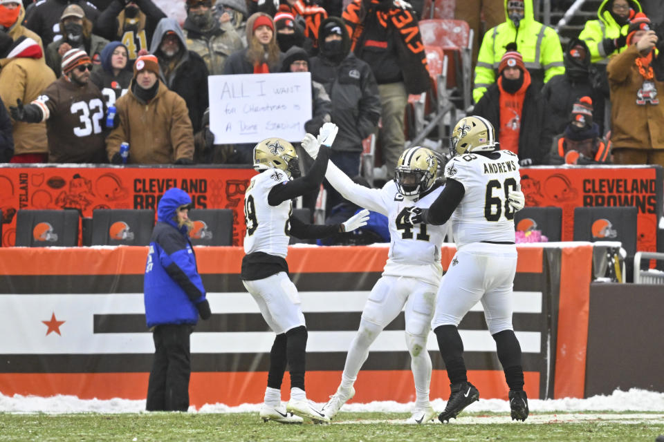 New Orleans Saints running back Alvin Kamara (41) is greeted by wide receiver Rashid Shaheed (89) and guard Josh Andrews (68) after scoring on a 4-yard rush during the second half of an NFL football game against the Cleveland Browns, Saturday, Dec. 24, 2022, in Cleveland. (AP Photo/David Richard)