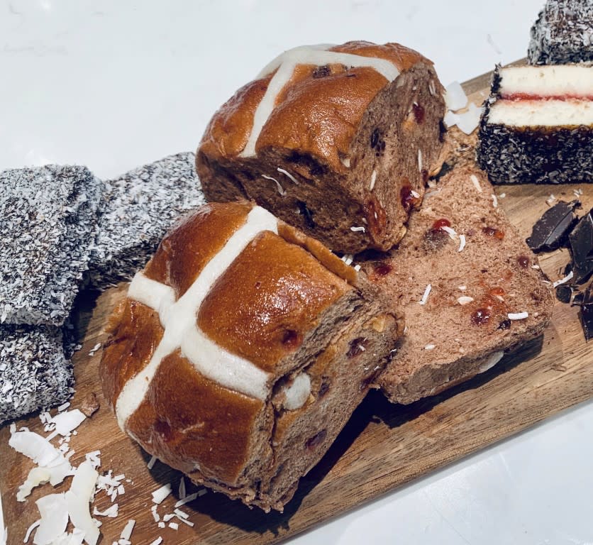 Coles lamington hot cross buns on a board with lamingtons