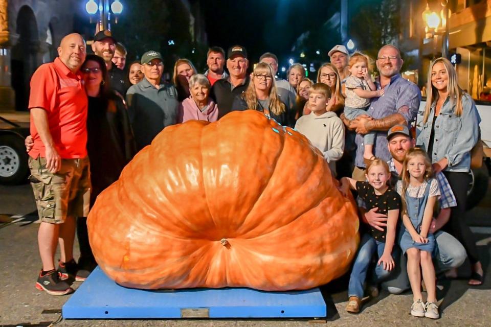 Bill Neptune, center, with family and his 2023 Barnesville Pumpkin Festival King Pumpkin. The 1,950-pound pumpkin will be on display throughout the four-day event.