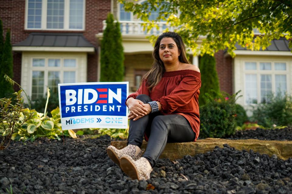 Aditi Bagchi of Northville, a dentist and mother of two, sits next to a sign endorsing Joe Biden for president in front of her home in Northville on Wednesday, September 16, 2020.
"I feel like so much has changed, like unbelievable change," Bagchi said, who started becoming more knowledgeable and politically active over the past few years. "My number one concern is my family. We are very fortunate but I feel like there are so many families that aren't as fortunate. If we're struggling how are they even managing," 