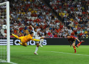 DONETSK, UKRAINE - JUNE 23: Xabi Alonso of Spain scores the first goal past Hugo Lloris of France during the UEFA EURO 2012 quarter final match between Spain and France at Donbass Arena on June 23, 2012 in Donetsk, Ukraine. (Photo by Laurence Griffiths/Getty Images)