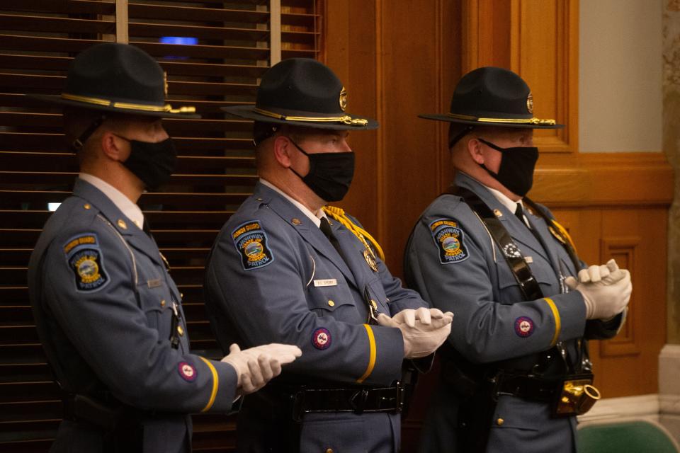 Members of the Kansas Highway Patrol applaud remarks made by Gov. Laura Kelly after she announced plans to increase officer pay within the department.