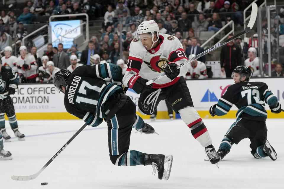 San Jose Sharks center Thomas Bordeleau (17) reaches for the puck next to Ottawa Senators right wing Mathieu Joseph (21) during the second period of an NHL hockey game in San Jose, Calif., Saturday, March 9, 2024. (AP Photo/Jeff Chiu)