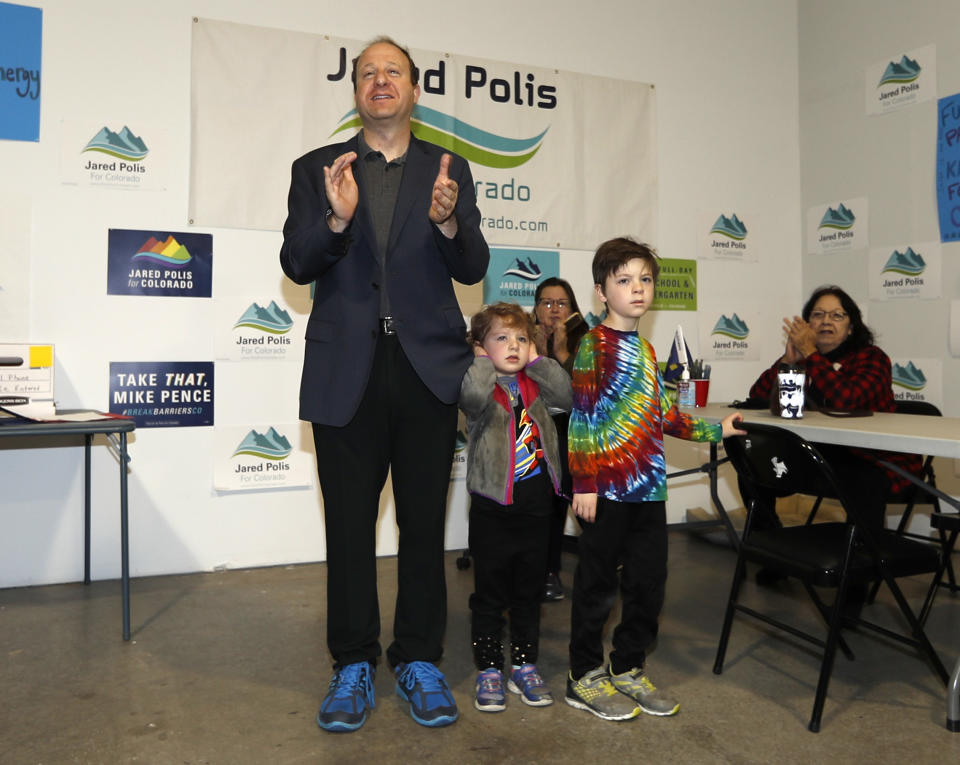 Jared Polis, left, Democratic candidate for Colorado's governorship, speaks to canvassers before they set out to talk to voters Saturday, Nov. 3, 2018, in north Denver. With Polis is his 4-year-old daughter, Cora, center, and 7-year-old son, Caspian. (AP Photo/David Zalubowski)