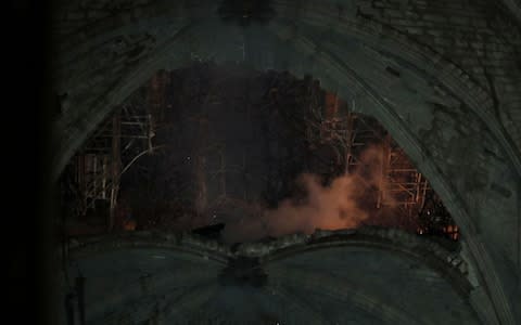 The huge hole in Notre-Dame's roof - Credit: Rex