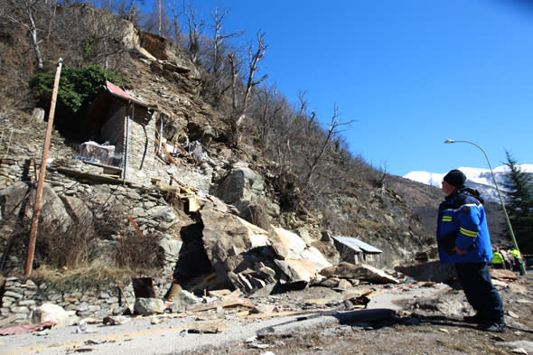 A French Gendarme looks at, on February 23, 2014 in Isola Village (French Alps), the mountain cottage destroyed by a rockslide which killed two children aged seven and ten. AFP PHOTO / JEAN CHRISTOPHE MAGNENET        (Photo credit should read JEAN CHRISTOPHE MAGNENET/AFP/Getty Images)