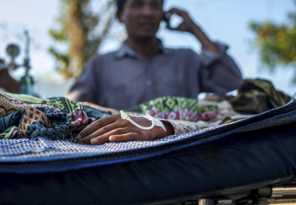 A man injured in an earthquake receives medical treatment at a makeshift hospital in Kayangan on Lombok Island, Indonesia, Monday, Aug. 6, 2018. Indonesian authorities said Monday that rescuers still haven't reached some devastated parts of the tourist island of Lombok after the powerful earthquake flattened houses and toppled bridges, killing large number of people and shaking neighboring Bali. (AP Photo/Fauzy Chaniago)