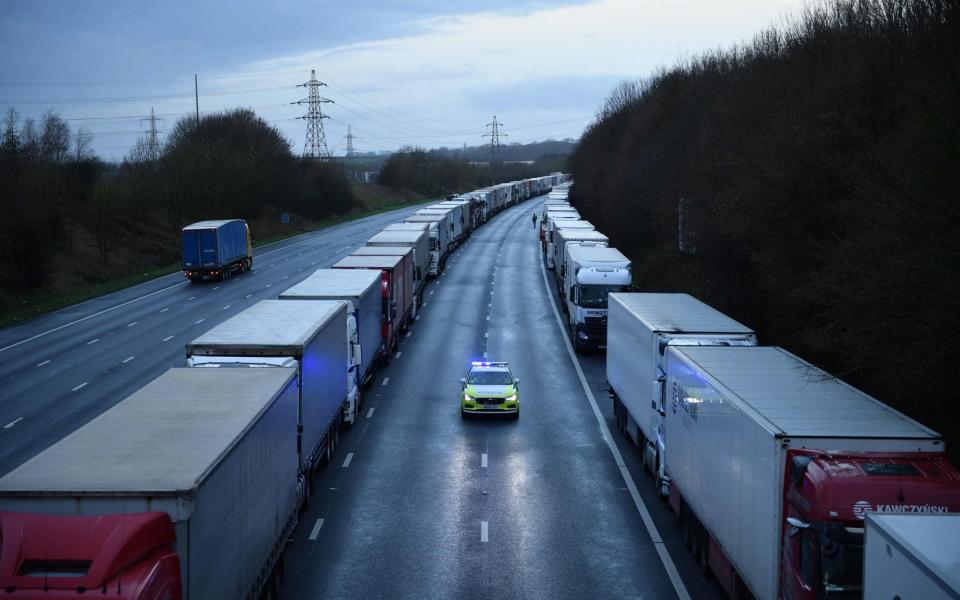 A police car patrols along the stacks of Freight lorries and goods vehicles queuing on the M20 - Justin Tallis/AFP