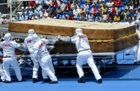 Mexican workers prepare the largest sandwich in the world, in the main Zocalo square in Mexico City, April 24, 2004. The sandwich, weighing 3,178 kg (6,991 pounds), was made by Mexican company Bimbo in conjunction with McCormick, Fud, Chalet and Petalo Jumbo. It was certified by Guinness Book of World Record officials today. REUTERS/Henry Romero